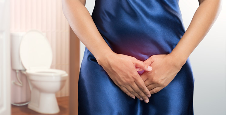 Woman with hands covering a red glow over her pelvic area.