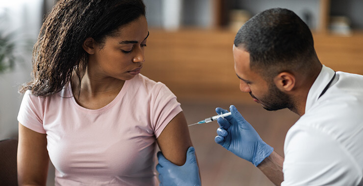 Doctor administering a flu vaccine