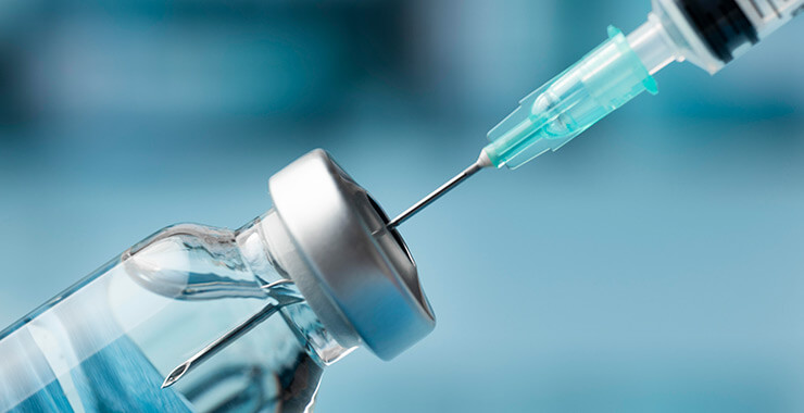 Close up of vaccine syringe and