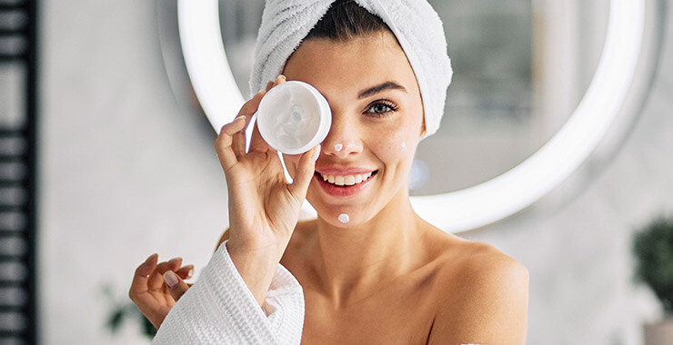 Young woman having fun with her skin care routine