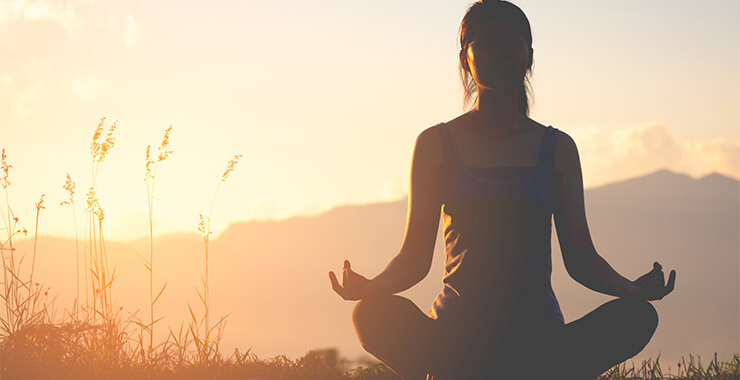 Woman meditating outdoors