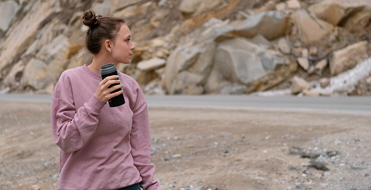 Woman drinking from a hydro flask