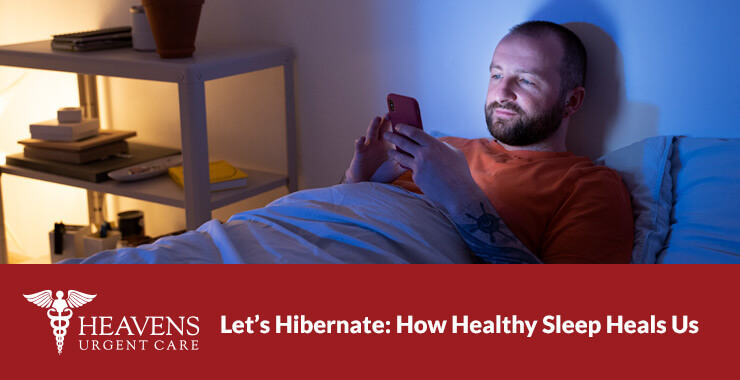 Man in bed looking at his phone.