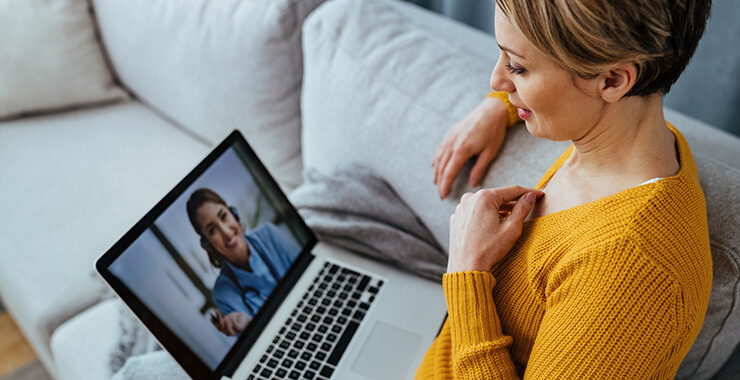 woman having Virtual Urgent care visit on lap top