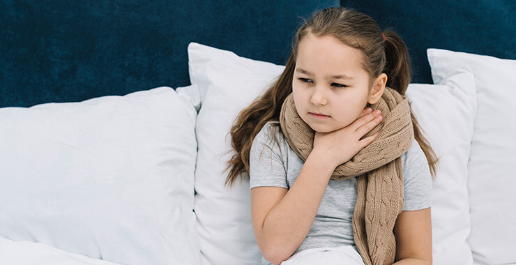 Girl holding her aching throat