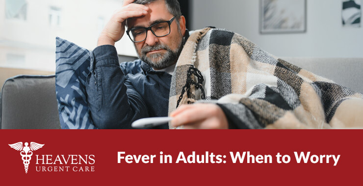 Middle age man holding his head and a thermometer