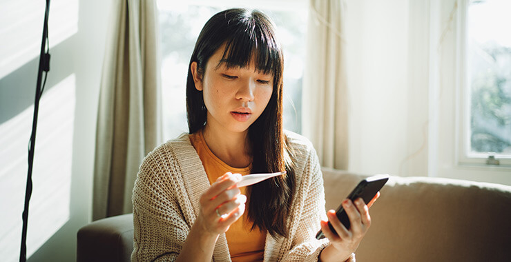Young Woman with Thermometer