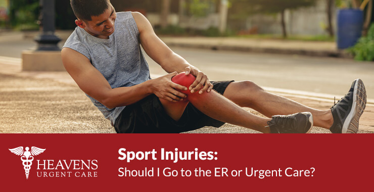 Young male runner fallen and gripping his right knee