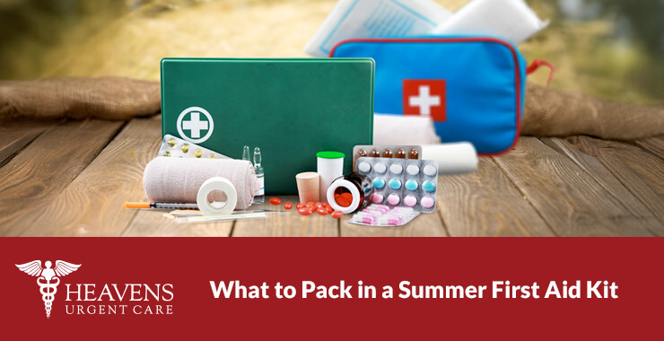 Summer first aid kit contents displayed on a wooden floor